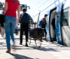 Cycliste homme de dos sur le quai d'une gare avec un train à l'arrêt